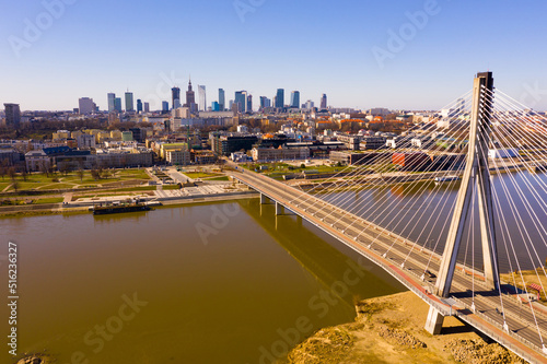 Panoramic view from drone of Warsaw modern cityscape on left bank of Vistula river with cable-stayed Swietokrzyski bridge in spring, Poland..