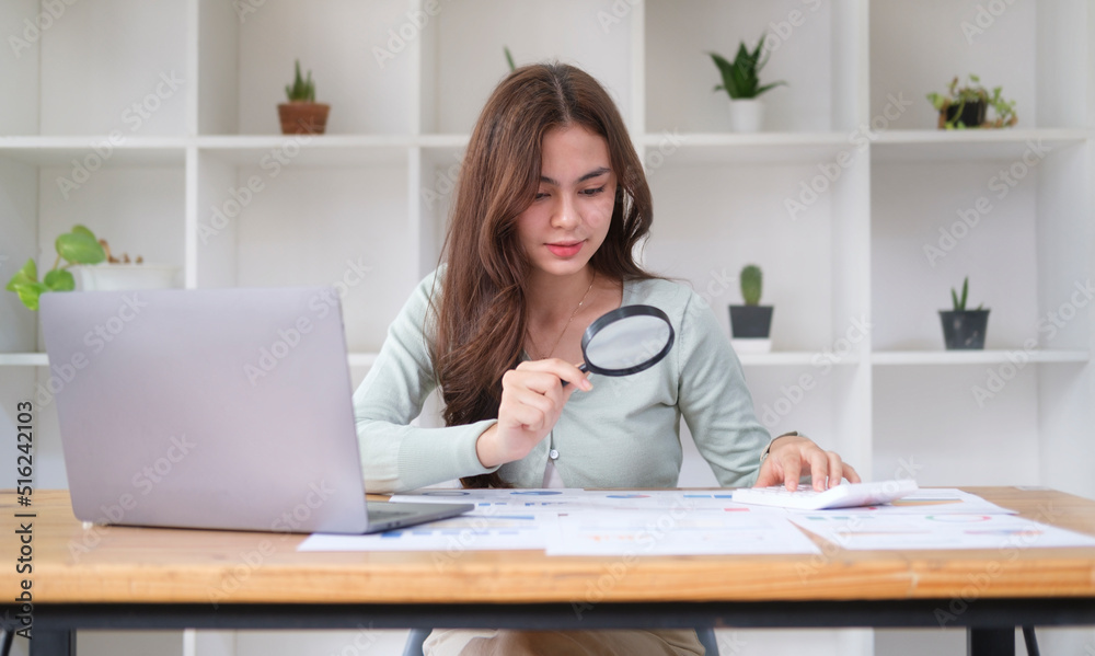 Investigator or auditor checking financial documents with magnifying glass over office desk. Investigator or auditor checking financial documents with magnifying glass over office desk.