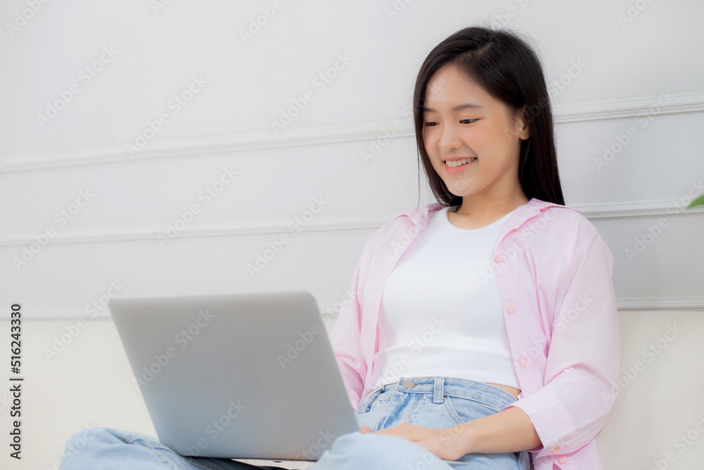 Young asian business woman work from home with laptop computer online to internet on sofa in living room, freelance girl using notebook sitting on couch with comfort and relax, lifestyles concept. Young asian business woman work from home with laptop computer online to internet on sofa in living room, freelance girl using notebook sitting on couch with comfort and relax, lifestyles concept.