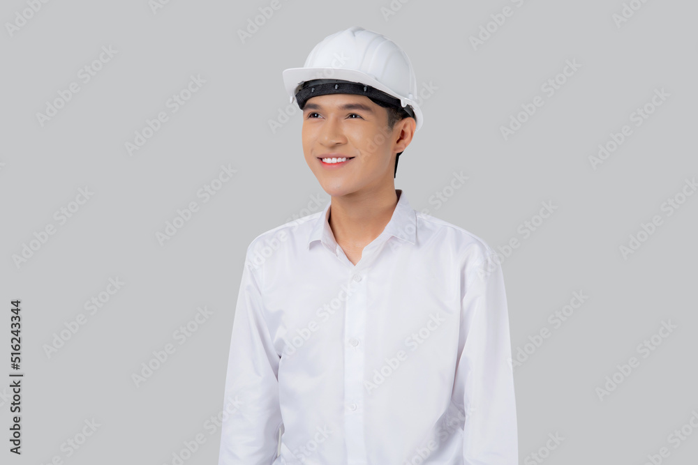 Portrait young asian man is engineer wearing helmet standing and holding blueprint with confident isolated on white background, handsome male is architect or contractor, worker or labor concept. Portrait young asian man is engineer wearing helmet standing and holding blueprint with confident isolated on white background, handsome male is architect or contractor, worker or labor concept.