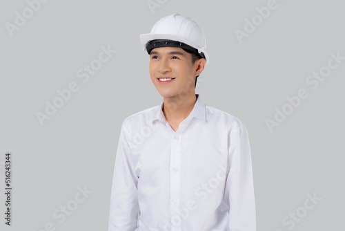 Portrait young asian man is engineer wearing helmet standing and holding blueprint with confident isolated on white background, handsome male is architect or contractor, worker or labor concept.