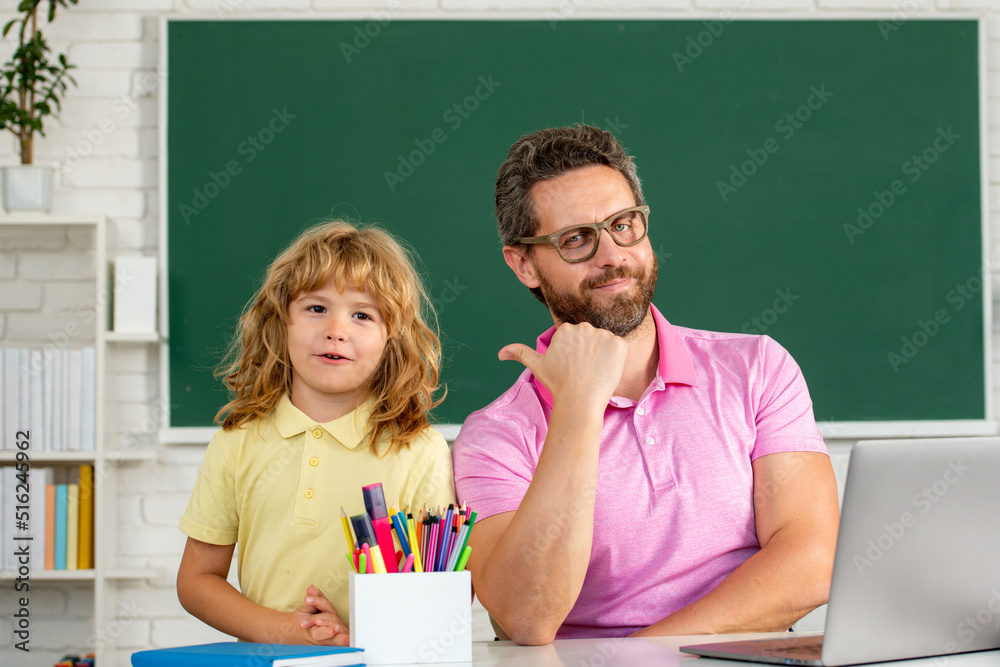 Father teacher helping a son boy in school lessons. Education and knowledge. Father teacher helping a son boy in school lessons. Education and knowledge.