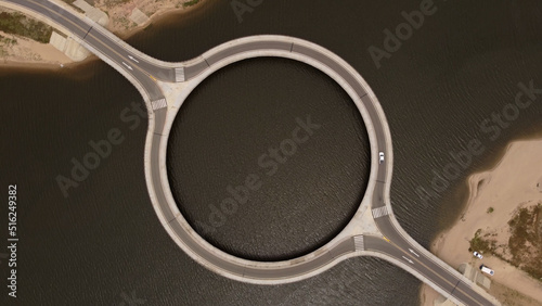 Aerial top down shot of empty Laguna Garzon Circular Bridge in Uruguay during sunlight.Aerial top down showing famous Laguna Garzón Bridge with circular shape. Located in Garzón, Uruguay