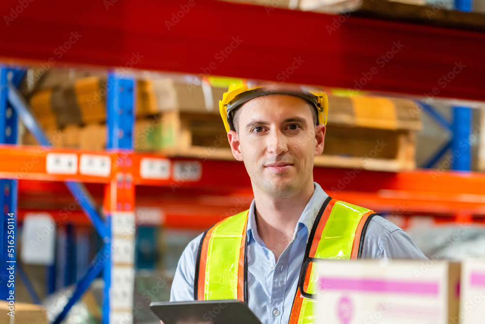 Smiling warehouse worker with digital tablet checking inventory in warehouse, Workers working in warehouse
