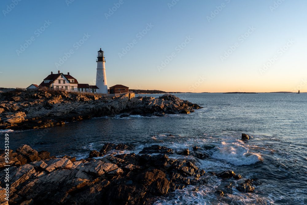 lighthouse on cliffs at sunrise