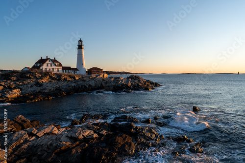 lighthouse on cliffs at sunrise