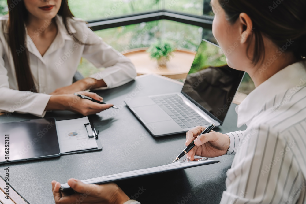 Marketer or analytic manager team dressed in suits working with paper charts and laptops at the meeting room. Marketer or analytic manager team dressed in suits working with paper charts and laptops at the meeting room.