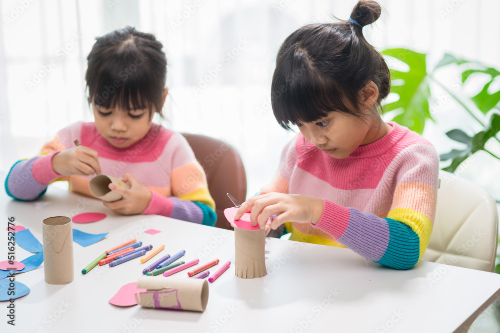 Portrait of a little asian girl cutting a paper in activities on DIY class at School.Scissors cut paper. Portrait of a little asian girl cutting a paper in activities on DIY class at School.Scissors cut paper.