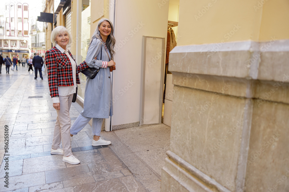 Female friends spending time at city street