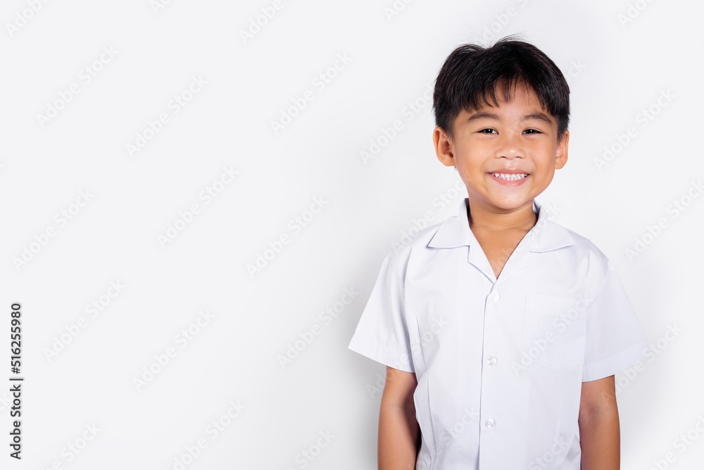 Asian adorable toddler smiling happy wearing student thai uniform standing in studio shot isolated on white background, Portrait little children boy preschool, Happy child Back to school Asian adorable toddler smiling happy wearing student thai uniform standing in studio shot isolated on white background, Portrait little children boy preschool, Happy child Back to school