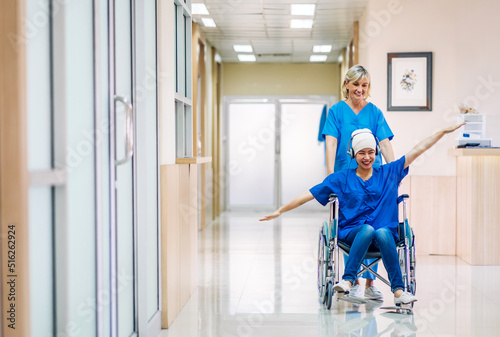 Professional medical doctor team with stethoscope in uniform discussing with patient woman with cancer cover head with headscarf of chemotherapy cancer in hospital.health care concept photo