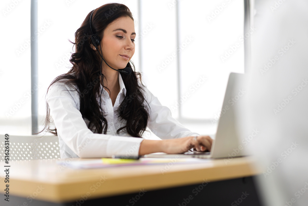 Group of happy call center smiling businesswoman operator customer help support team phone services agen working and talking with headset on desktop computer at call center office Group of happy call center smiling businesswoman operator customer help support team phone services agen working and talking with headset on desktop computer at call center office