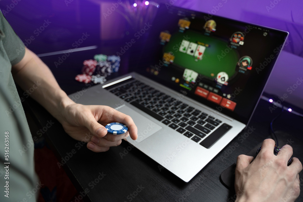 Young man play online poker in laptop. Young man play online poker in laptop.