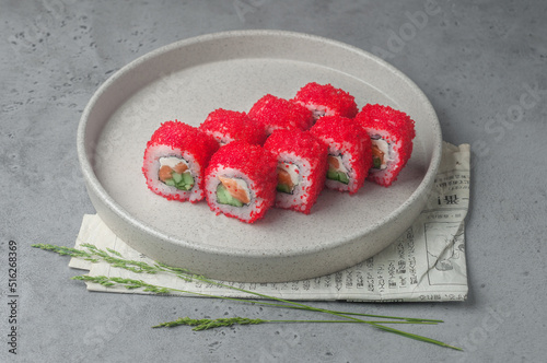 maki sushi with masago caviar on gray background photo