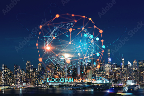New York City skyline from New Jersey over the Hudson River with the skyscrapers at night, Manhattan, Midtown, USA. Decentralized economy. Blockchain, cryptography and cryptocurrency concept, hologram