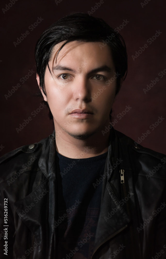 young hispanic man with black jacket and red wine background portrait classic art 