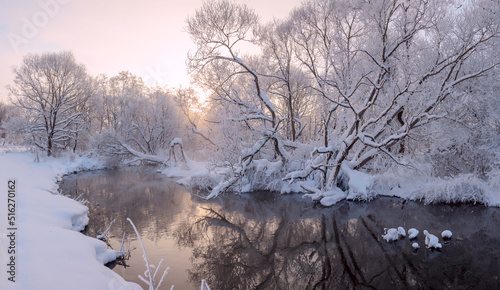 Winter scene with calm forest river 