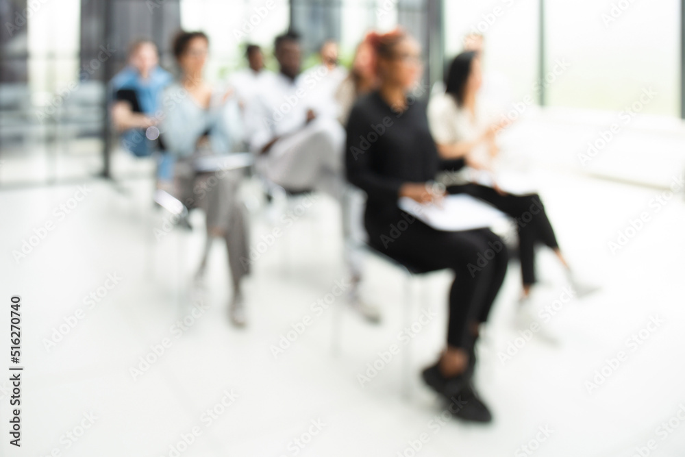 Blurred image of business people sitting in the office Blurred image of business people sitting in the office