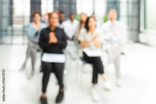Blurred image of business people sitting in the office