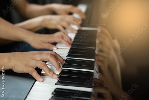 Piano Keyboard side corner and Hands of lover playing music.