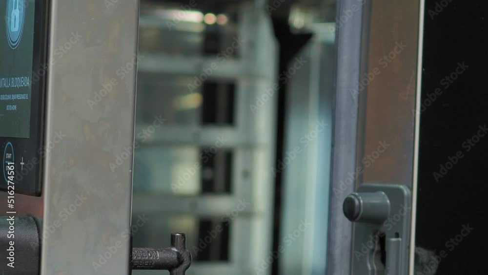 Hand opening and closing door of industrial kitchen oven. Gimbal, close up Hand opening and closing door of industrial kitchen oven. Gimbal, close up