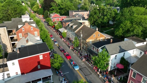 Family and friends gather to watch parade in small town USA. Aerial at golden hour. Historic district homes. Lititz Pennsylvania USA. photo