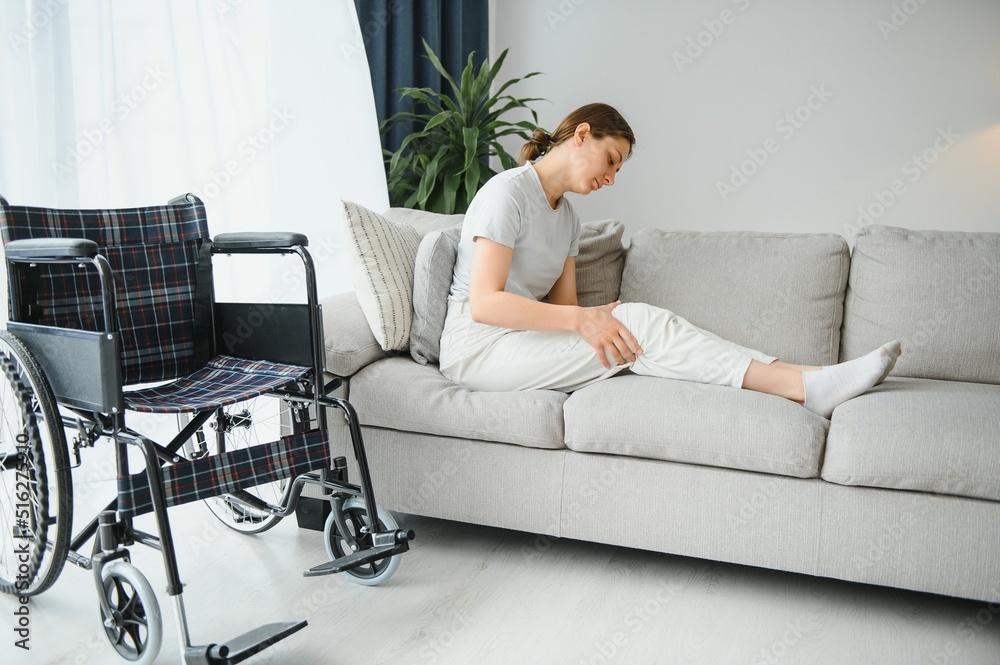 woman trying to sit down in wheelchair from couch