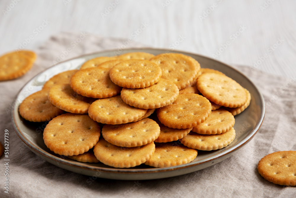 Salty Round Crackers on a Plate, side view.