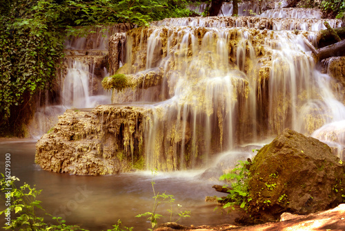 Fototapeta Naklejka Na Ścianę i Meble -  Krushuna waterfalls turquoise water terraces and pools, the biggest travertine cascade in Bulgaria
