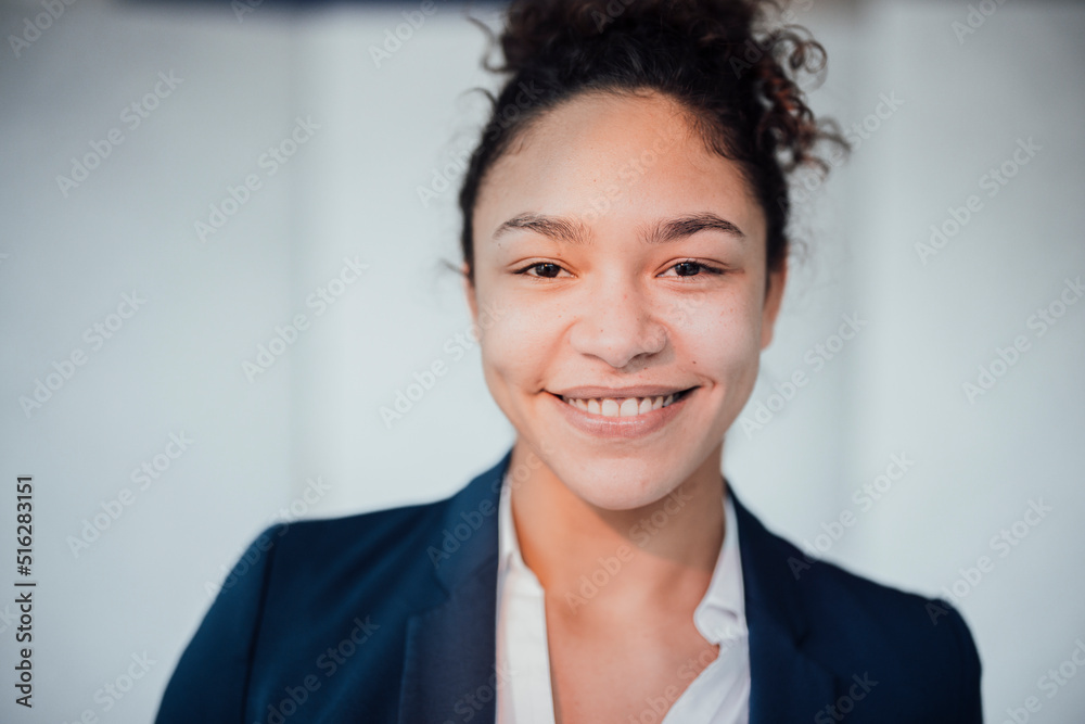 Happy businesswoman wearing blazer in office Happy businesswoman wearing blazer in office