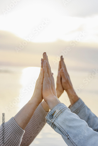 Girlfriend and boyfriend touching hands at sunset photo