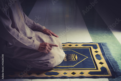 religious muslim man pray on prayer cloth in mosque,gester of prayer,concept for rite in islam,workship,religion photo