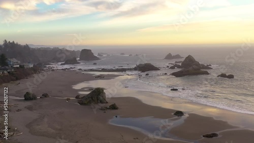 Harris Beach in Brookings, Oregon. Sunset 4k drone flight over beach and sea stacks photo