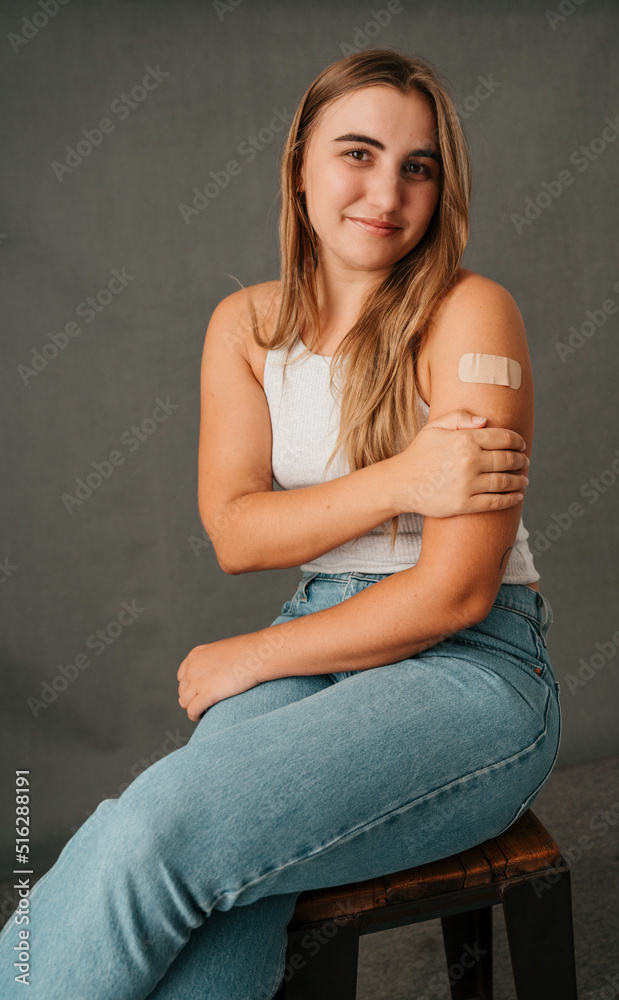 Close up Caucasian female holding her injured arm sitting on a chair