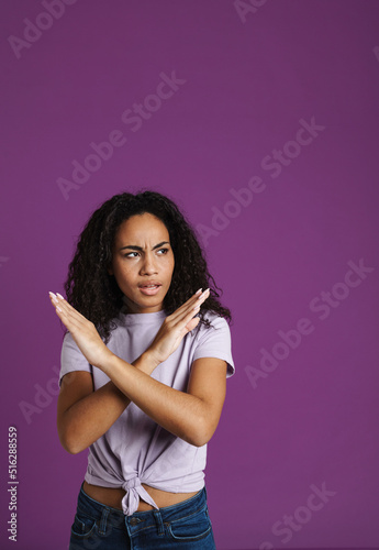 Young black woman frowning while showing stop gesture