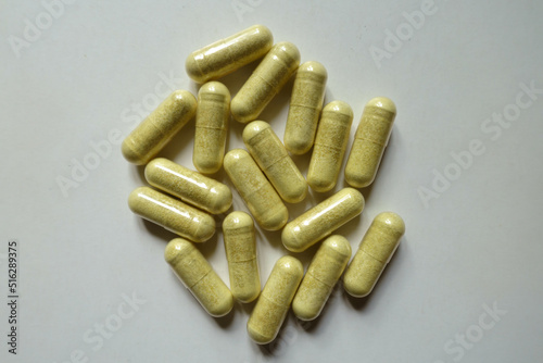 Group of yellowish green capsules of quercetin dietary supplement from above photo