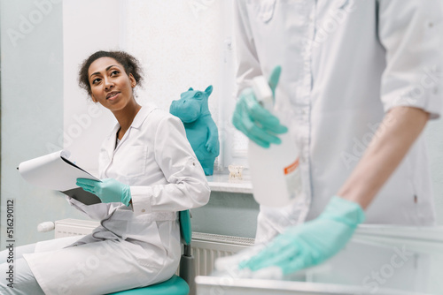 Multiracial two dentists working in dental clinic
