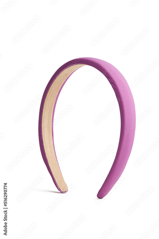 Subject shot of a wide violet headband covered with silky fabric. The hairband is isolated on the white background. Vogue accessory for ladies and girls. Subject shot of a wide violet headband covered with silky fabric. The hairband is isolated on the white background. Vogue accessory for ladies and girls.