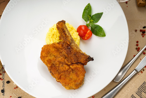 beef steak in batter with mashed potatoes in a plate
