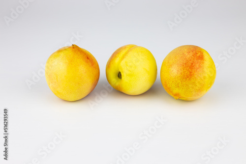 Peaches, nectarines on a white background, close-up.