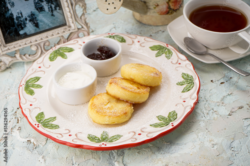 cheese cake dessert in a white plate on the table with tea
cheese cake dessert in a white plate on the table with tea