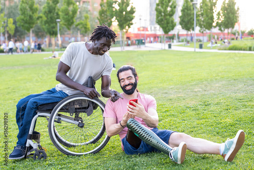 two friends with disability chatting and using smartphone outdoor, people using modern device to communicate