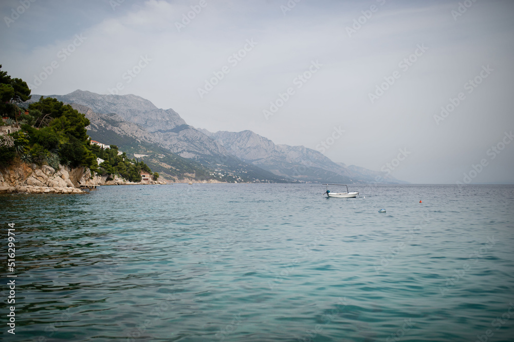 Landscape of town in the Adriatic sea coast under mountain in Croatia, during summer sunny day