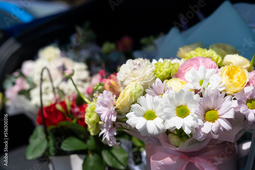 Bouquets of beautiful bright multi-colored flowers in the trunk of a car, a gift for a wedding, for a birthday
