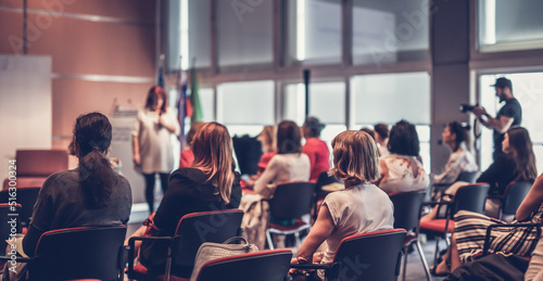 Woman giving presentation on business conference event. photo