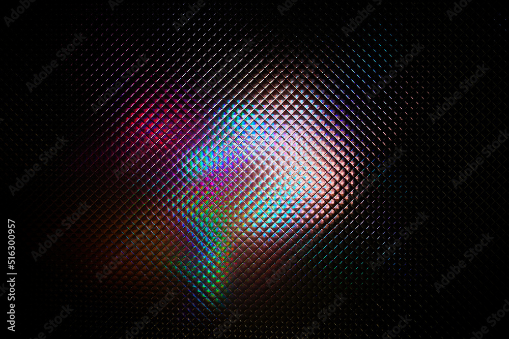 Multicolored abstract colorful pattern. Light glares with a spectral gradient on a dark background.