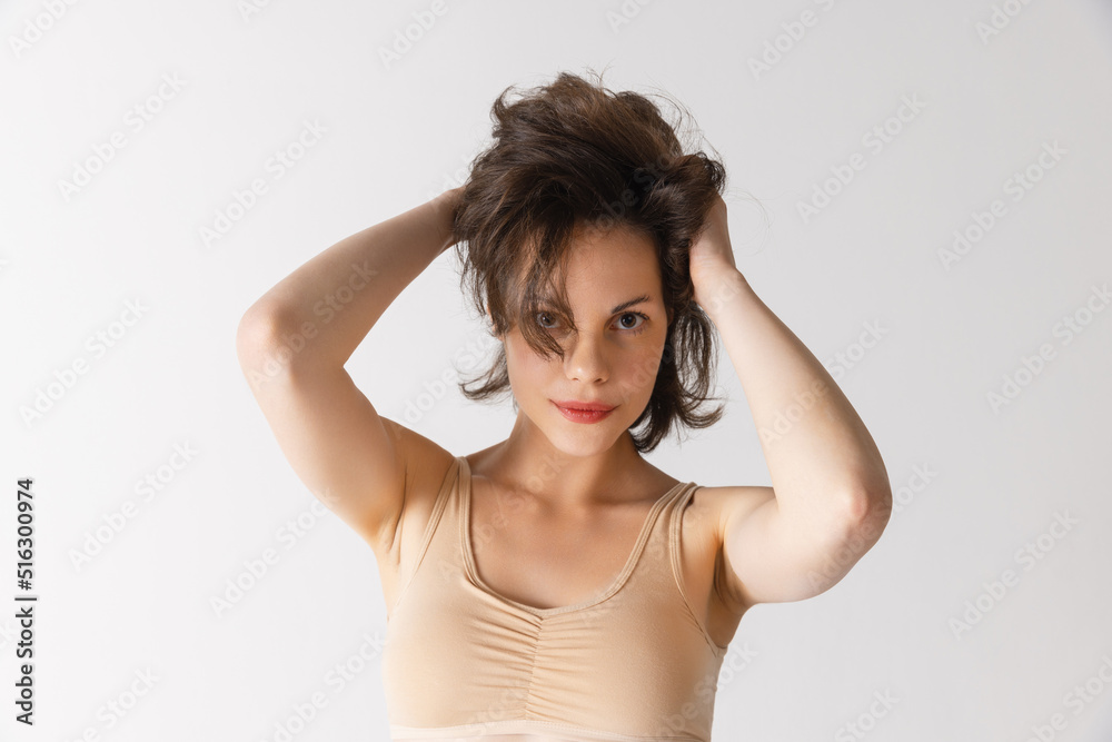 Young pretty woman with well-kept skin without makeup isolated on white studio background. Spa, cosmetics, face lifting and skin care concept Young pretty woman with well-kept skin without makeup isolated on white studio background. Spa, cosmetics, face lifting and skin care concept