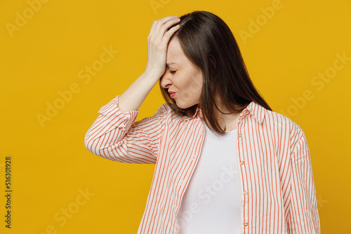 Young mistaken woman she 30s wears striped shirt white t-shirt put hand on face facepalm epic fail mistaken omg gesture isolated on plain yellow background studio portrait. People lifestyle concept.