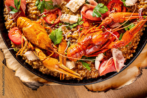 Gourmet seafood paella with pink marine prawns and mussels
