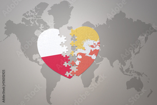 puzzle heart with the national flag of bhutan and poland on a world map background.Concept.